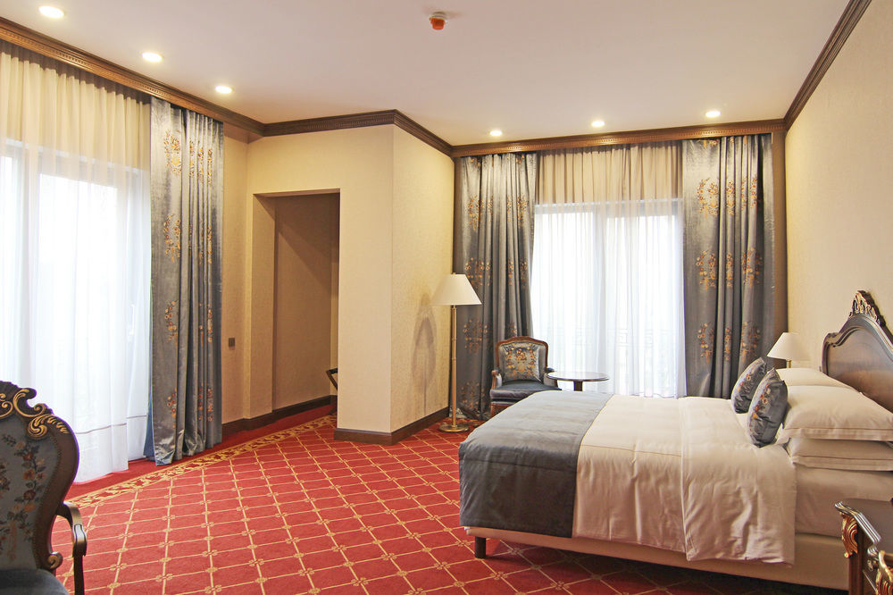 Orion Hotel Bishkek Esterno foto A bedroom at the hotel